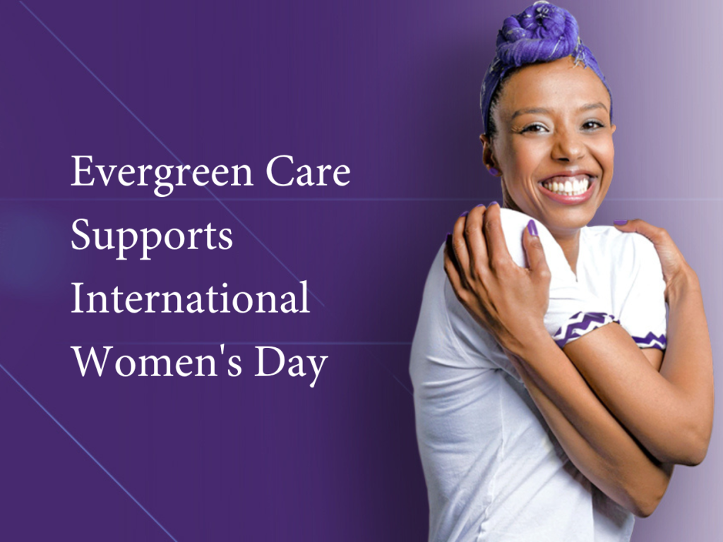 Image of young black female smiling and hugging herself as part of International Women's Day for Evergreen Care