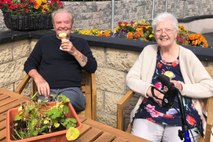 Two residents of Raheny House Nursing Home enjoying ice cream in the garden