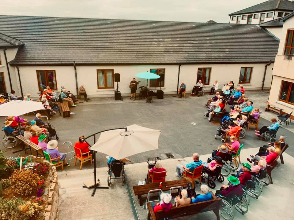 A group of residents at Esker Rí Nursing Home listening to live music