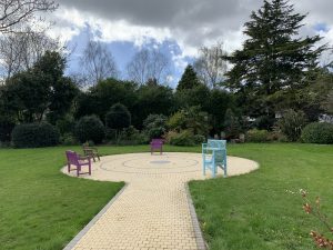 Outdoor scene in Greystones Nursing home showing chairs set out in garden