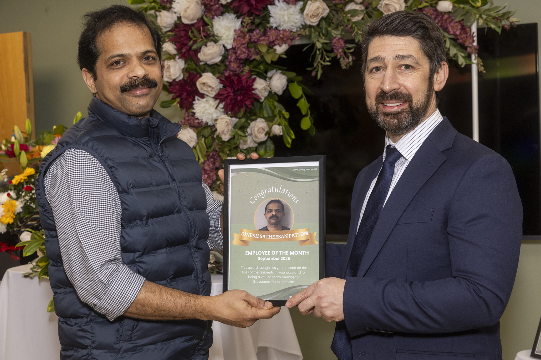 Dinesh Satheesan Pattom receiving an Evergreen Care employee recognition award